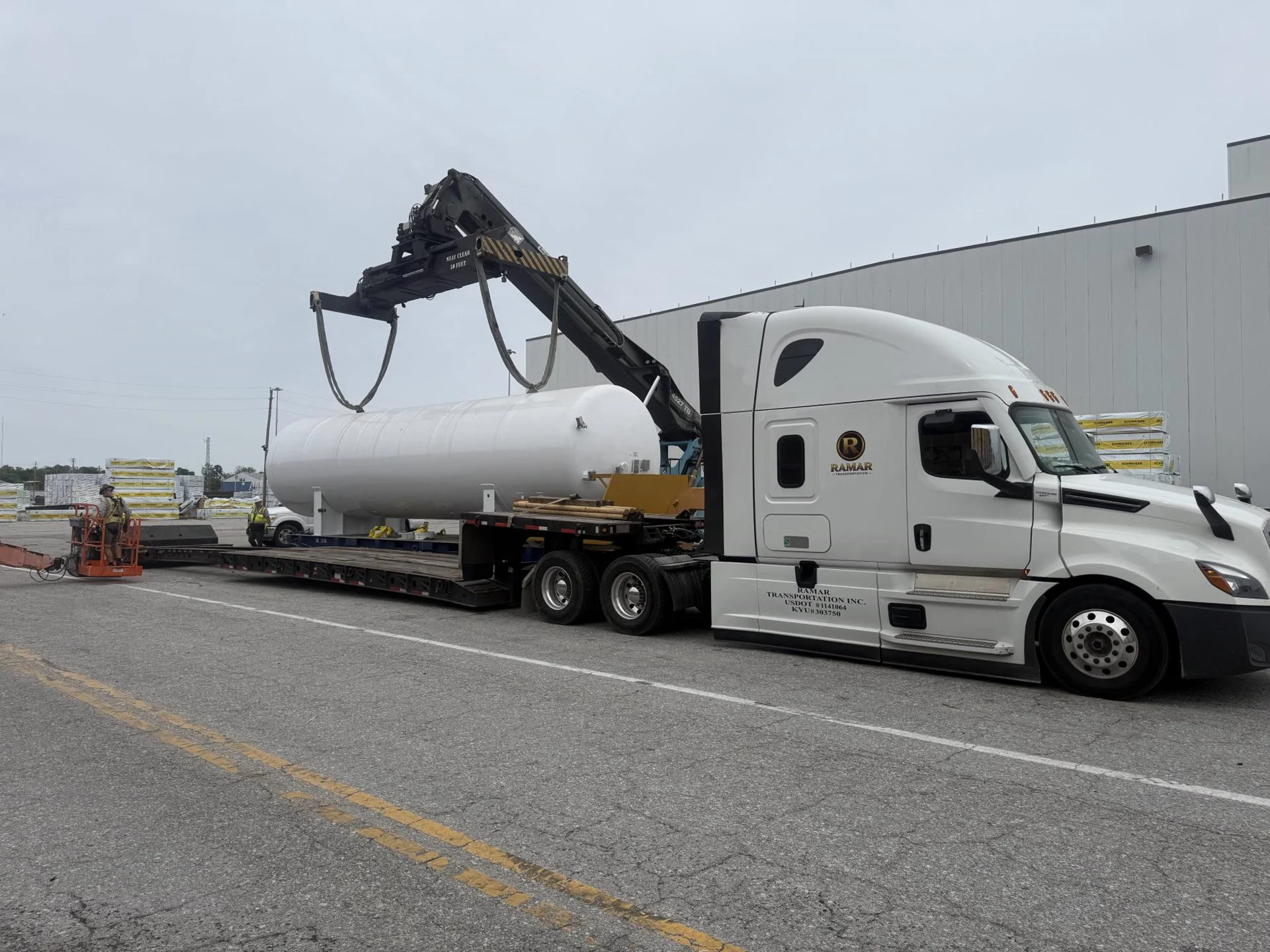 Ramar Transportation tractor with flatbed-mounted pressure vessel staged at a customer site