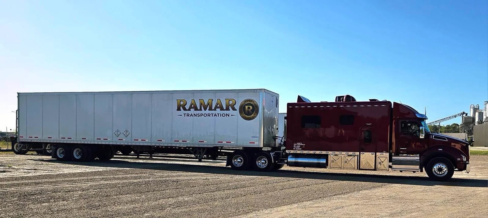 Ramar Transportation team-driver sleeper tractor with branded trailer staged at the yard
